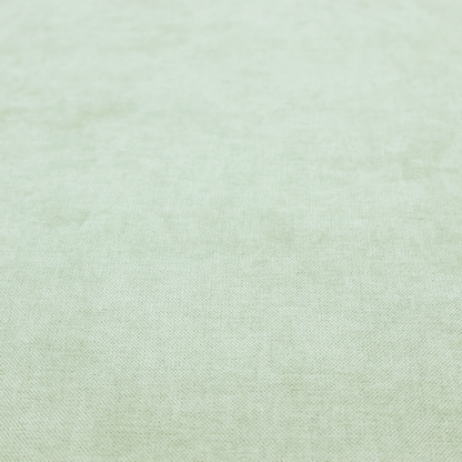 A textured, light mint green or pale sage green woven upholstery fabric.