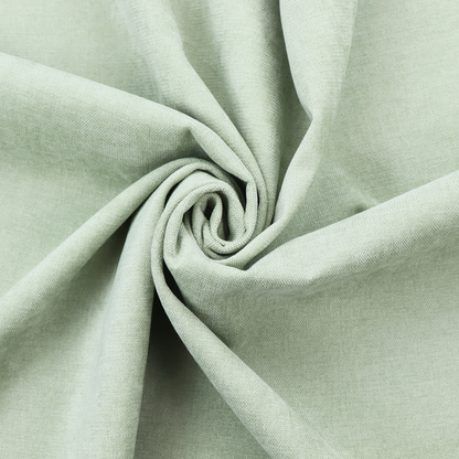 A textured, light mint green or pale sage green woven upholstery fabric.