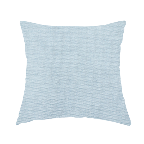 The fabric used to create this handmade cushion is a textured, light blue or pale sky blue woven upholstery fabric.