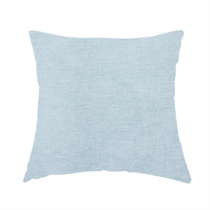The fabric used to create this handmade cushion is a textured, light blue or pale sky blue woven upholstery fabric.