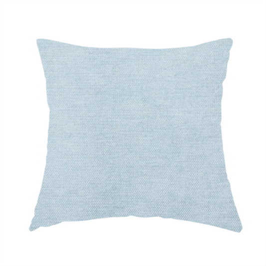 The fabric used to create this handmade cushion is a textured, light blue or pale sky blue woven upholstery fabric.