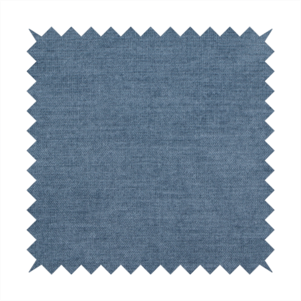 A textured, denim blue or dusty blue woven upholstery fabric.