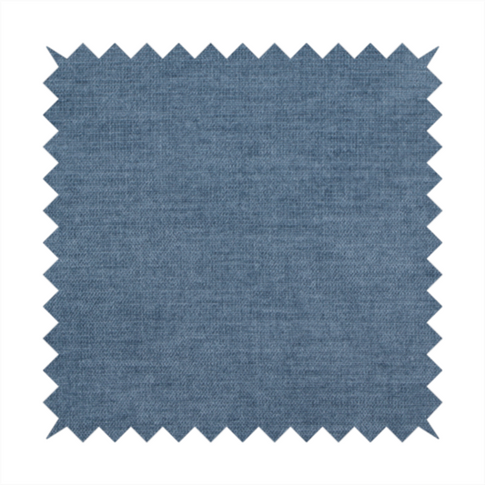 A textured, denim blue or dusty blue woven upholstery fabric.