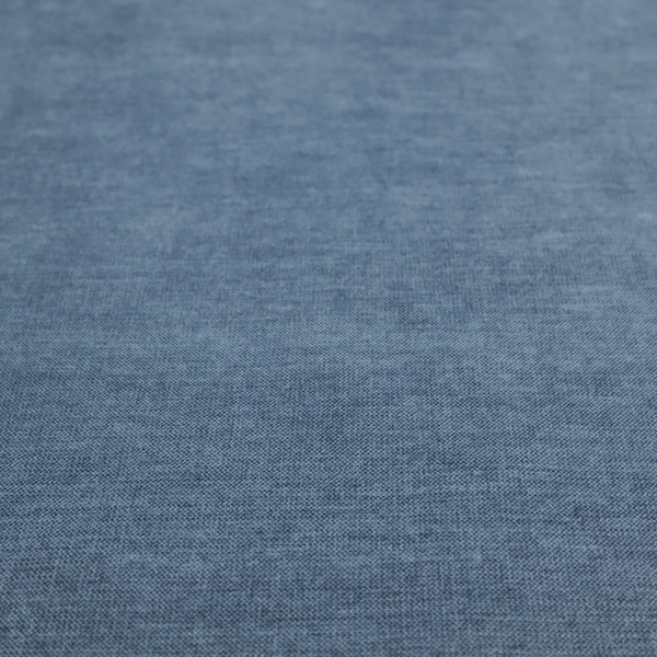 A textured, denim blue or dusty blue woven upholstery fabric.