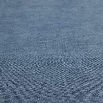 A textured, denim blue or dusty blue woven upholstery fabric.