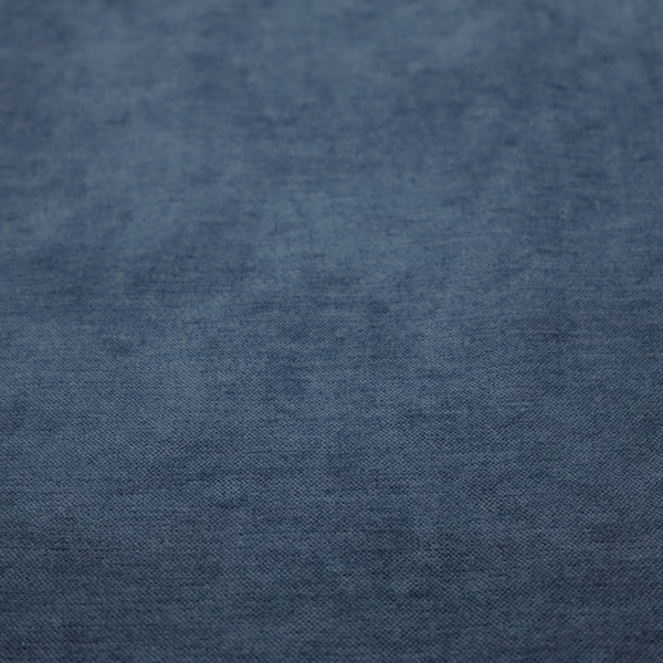 A textured, dark denim blue or navy blue woven upholstery fabric.