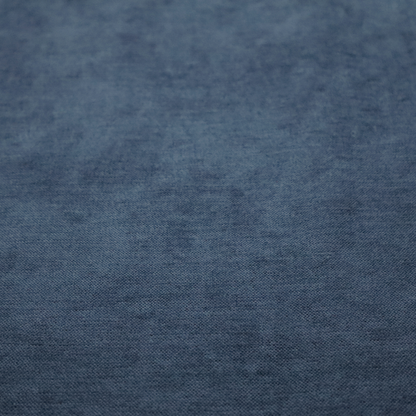 A textured, dark denim blue or navy blue woven upholstery fabric.