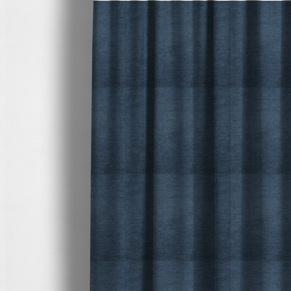 The fabric used to create these made-to-measure curtains is a textured, dark denim blue or navy blue woven upholstery fabric.