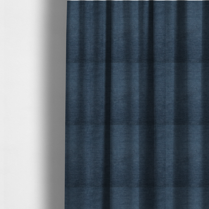 The fabric used to create these made-to-measure curtains is a textured, dark denim blue or navy blue woven upholstery fabric.