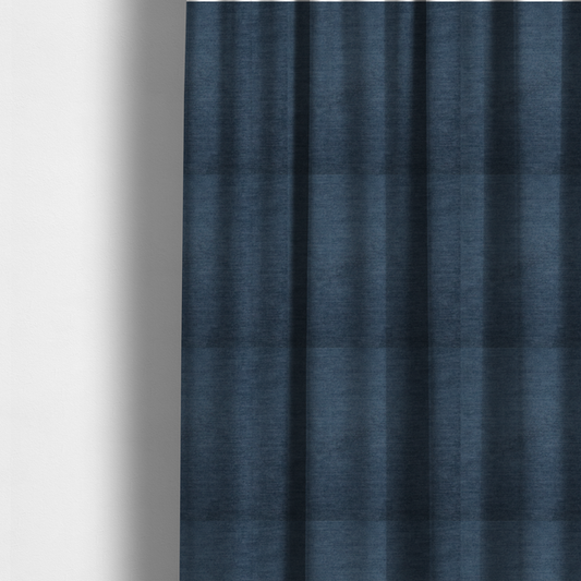 The fabric used to create these made-to-measure curtains is a textured, dark denim blue or navy blue woven upholstery fabric.