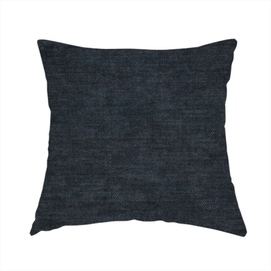 The fabric used to create this handmade cushion is a textured, dark charcoal grey or near-black woven upholstery fabric.