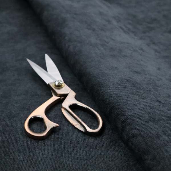A textured, dark charcoal grey or near-black woven upholstery fabric.
