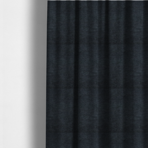 The fabric used to create these made-to-measure curtains is a textured, dark charcoal grey or near-black woven upholstery fabric.