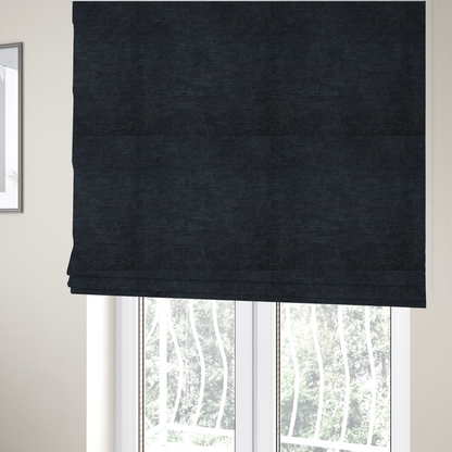 The fabric used to create these Roman blinds is a textured, dark charcoal grey or near-black woven upholstery fabric.