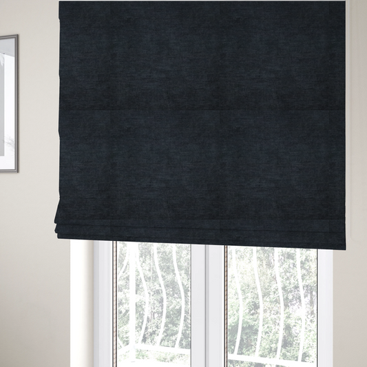 The fabric used to create these Roman blinds is a textured, dark charcoal grey or near-black woven upholstery fabric.