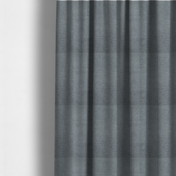 The fabric used to create these made-to-measure curtains is a textured, medium grey or steel grey woven upholstery fabric.