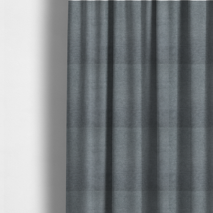 The fabric used to create these made-to-measure curtains is a textured, medium grey or steel grey woven upholstery fabric.