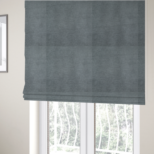 The fabric used to create these Roman blinds is a textured, medium grey or steel grey woven upholstery fabric.
