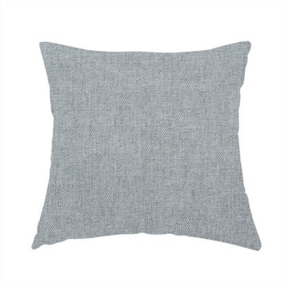 The fabric used to create this handmade cushion is a textured, light grey or silver grey woven upholstery fabric.