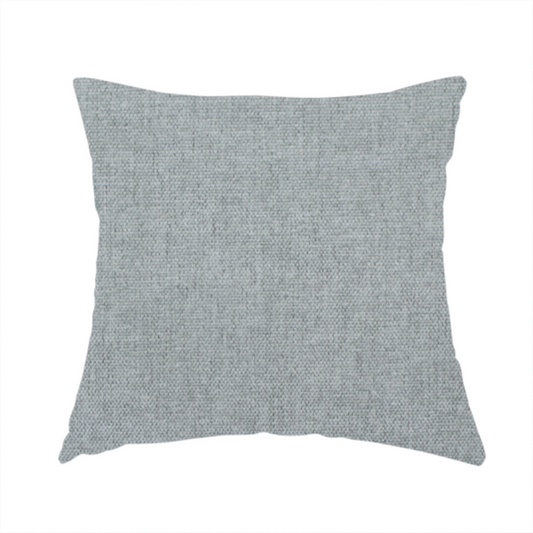 The fabric used to create this handmade cushion is a textured, light grey or silver grey woven upholstery fabric.