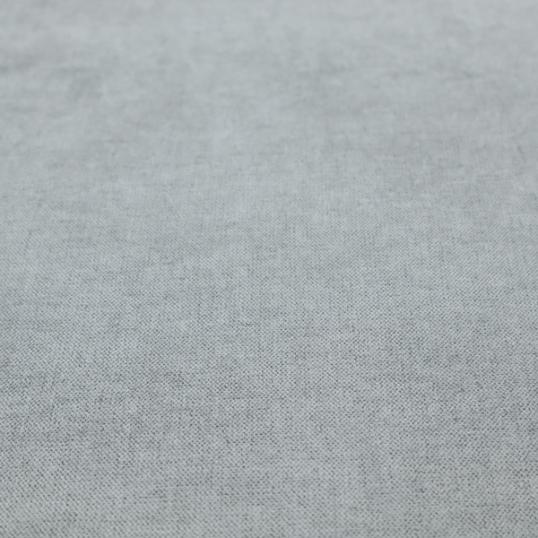 A textured, light grey or silver grey woven upholstery fabric.
