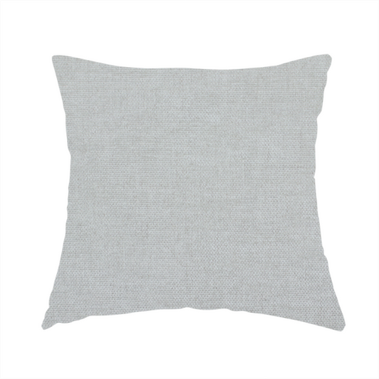 The fabric used to create this handmade cushion is a textured, very light grey or off-white woven upholstery fabric.