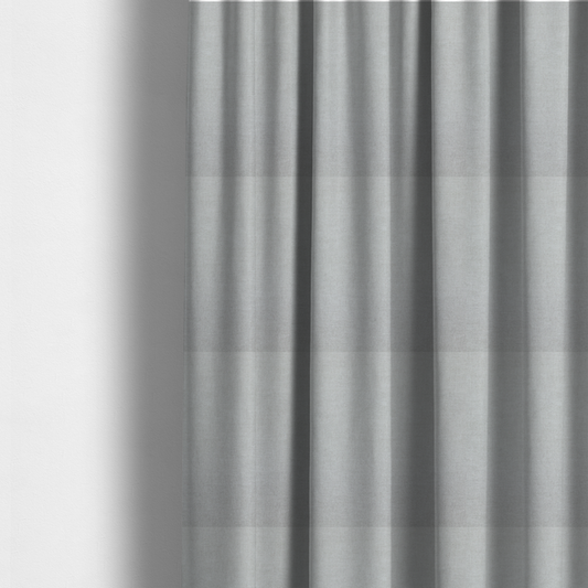 The fabric used to create these made-to-measure curtains is a textured, very light grey or off-white woven upholstery fabric.