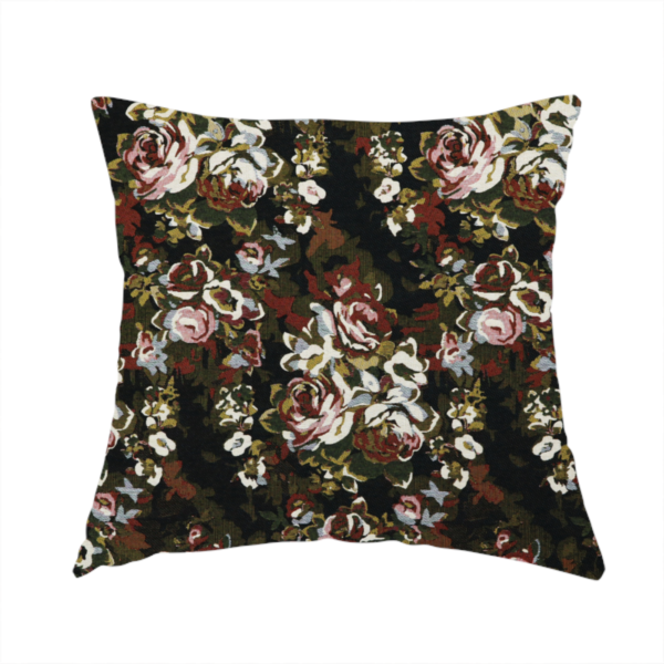 The fabric used to create this handmade cushion is a repeating vintage floral pattern on a dark black and olive green woven fabric background. The pattern features clusters of blooming roses in shades of dusty pink, burgundy, cream, and muted light blue, accompanied by small accent flowers and olive green leaves.   