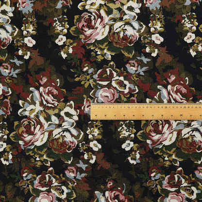 A repeating vintage floral pattern on a dark black and olive green woven fabric background. The pattern features clusters of blooming roses in shades of dusty pink, burgundy, cream, and muted light blue, accompanied by small accent flowers and olive green leaves.   
