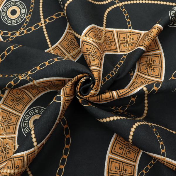 A glamorous luxury-style upholstery fabric on a black background featuring a repeating pattern of large gold-and-white patterned circular rings interconnected by dangling gold chains and small black-and-white geometric medallions.   