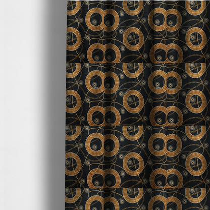 The fabric used to create these made-to-measure curtains is a glamorous luxury-style upholstery fabric on a black background featuring a repeating pattern of large gold-and-white patterned circular rings interconnected by dangling gold chains and small black-and-white geometric medallions.   