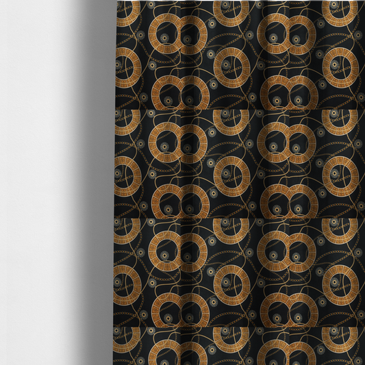 The fabric used to create these made-to-measure curtains is a glamorous luxury-style upholstery fabric on a black background featuring a repeating pattern of large gold-and-white patterned circular rings interconnected by dangling gold chains and small black-and-white geometric medallions.   