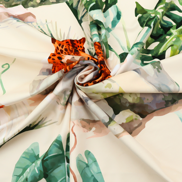 A tropical fabric pattern featuring leopards lounging on rocks amidst lush green foliage, palm fronds, and vibrant orange birds against a light background.