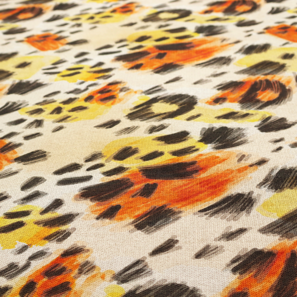 An abstract leopard print fabric featuring a light beige background with painterly, watercolour-style spots in shades of burnt orange, vibrant yellow, and charcoal black, accented with dashed, hand-drawn sketch lines.