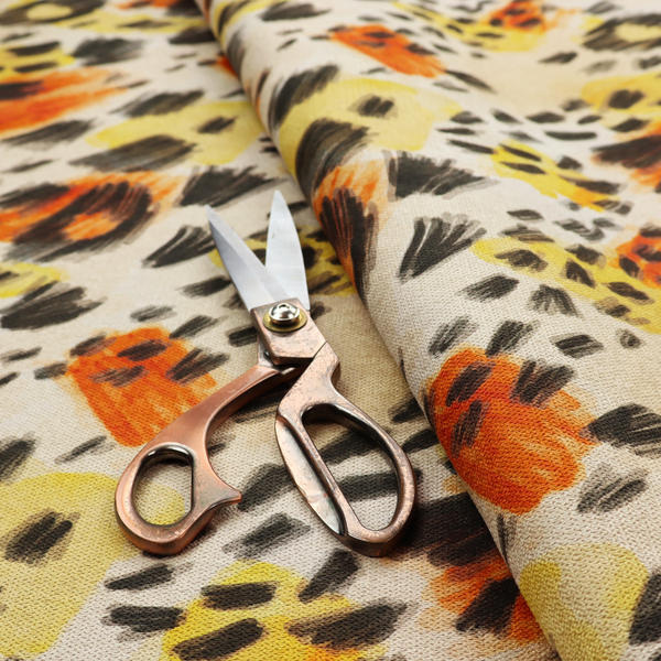 An abstract leopard print fabric featuring a light beige background with painterly, watercolour-style spots in shades of burnt orange, vibrant yellow, and charcoal black, accented with dashed, hand-drawn sketch lines.