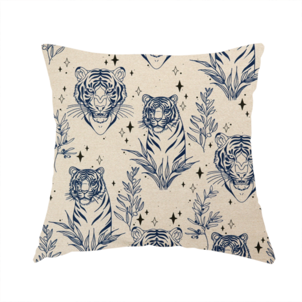 The fabric used to create this handmade cushion is a seamless pattern fabric featuring line-drawn navy blue tigers, leafy botanical branches, and small sparkling star accents set against a light beige background.   