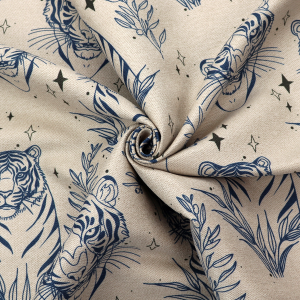 A seamless pattern fabric featuring line-drawn navy blue tigers, leafy botanical branches, and small sparkling star accents set against a light beige background.   