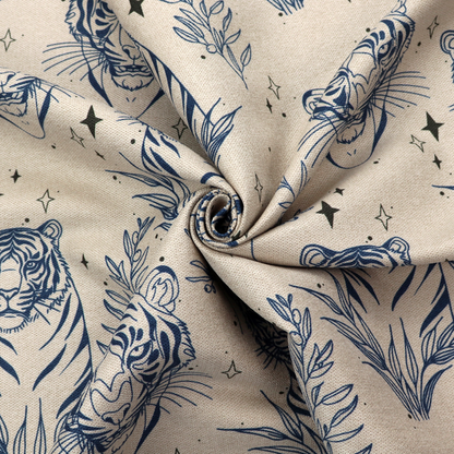 A seamless pattern fabric featuring line-drawn navy blue tigers, leafy botanical branches, and small sparkling star accents set against a light beige background.   