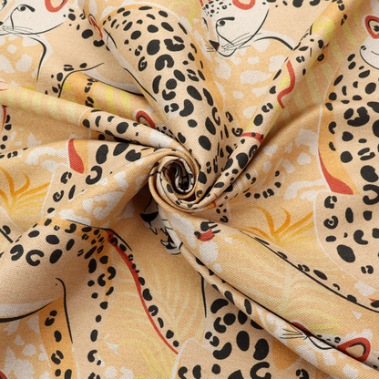 A playful patterned fabric featuring illustrated leopards in various poses with black spots and red-tipped ears, set against a warm yellow and beige jungle foliage background.   