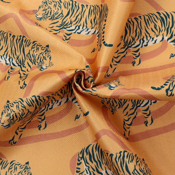 A striking upholstery fabric on a warm mustard-yellow background featuring a repeating pattern of prowling tigers in black stripes over abstract terracotta-coloured organic shapes.   
