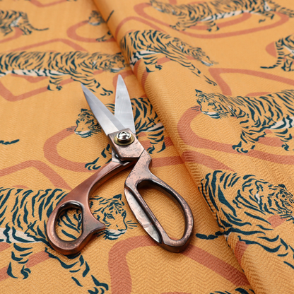 A striking upholstery fabric on a warm mustard-yellow background featuring a repeating pattern of prowling tigers in black stripes over abstract terracotta-coloured organic shapes.   