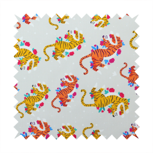 A playful patterned fabric featuring whimsical leaping tigers in shades of orange and yellow, accented with colourful floral elements on a light grey background.   