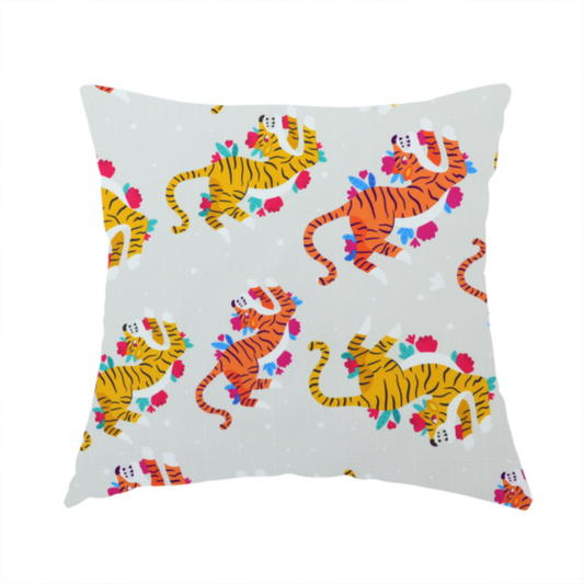 The fabric used to create this handmade cushion is a playful patterned fabric featuring whimsical leaping tigers in shades of orange and yellow, accented with colourful floral elements on a light grey background.   