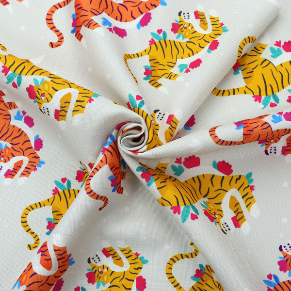 A playful patterned fabric featuring whimsical leaping tigers in shades of orange and yellow, accented with colourful floral elements on a light grey background.   