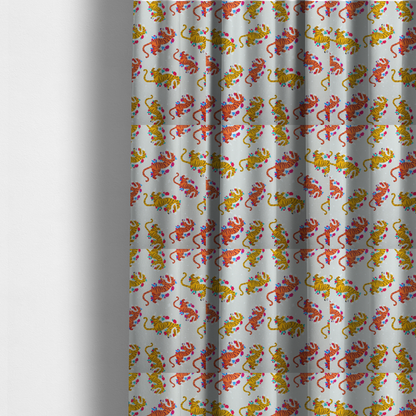 The fabric used to create these made-to-measure curtains is a playful patterned fabric featuring whimsical leaping tigers in shades of orange and yellow, accented with colourful floral elements on a light grey background.   