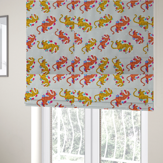 The fabric used to create these Roman blinds is a playful patterned fabric featuring whimsical leaping tigers in shades of orange and yellow, accented with colourful floral elements on a light grey background.   
