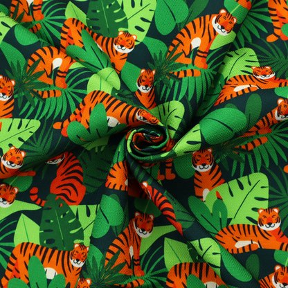 A vibrant jungle pattern fabric featuring orange and black tigers nestled among lush green tropical leaves and foliage against a dark background.   