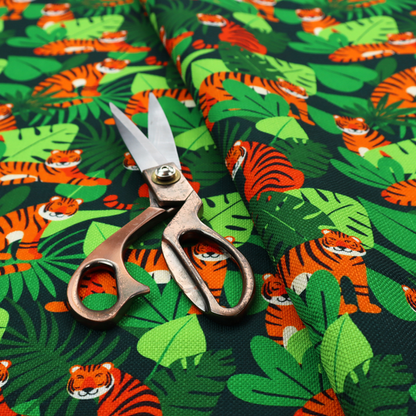 A vibrant jungle pattern fabric featuring orange and black tigers nestled among lush green tropical leaves and foliage against a dark background.   