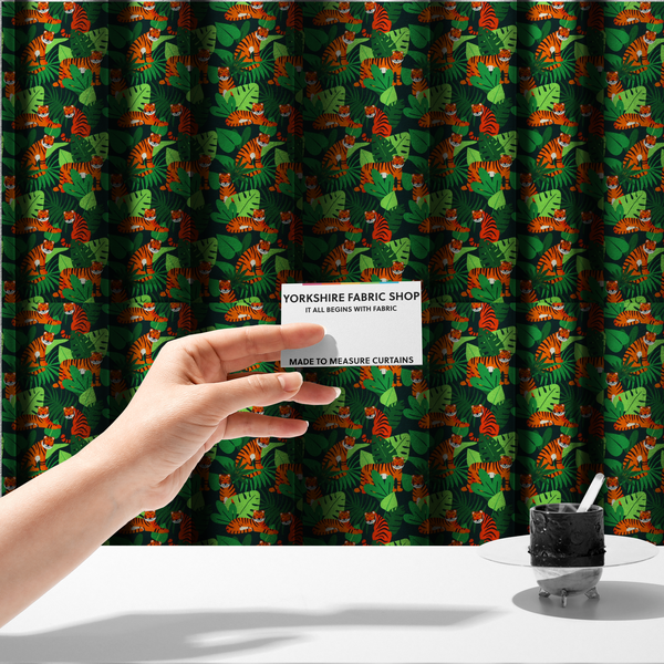 The fabric used to create these made-to-measure curtains is a vibrant jungle pattern fabric featuring orange and black tigers nestled among lush green tropical leaves and foliage against a dark background.   
