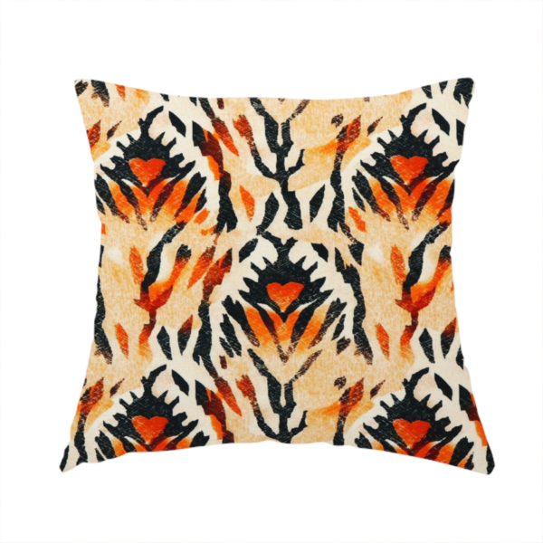 The fabric used to create this handmade cushion is a abstract ikat fabric pattern featuring symmetrical, feather-like motifs in shades of burnt orange, cream, and dark charcoal black against a textured light background.   